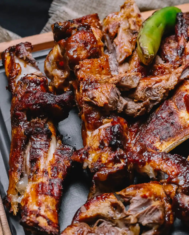 Grilled ribs on a plate with a green pepper